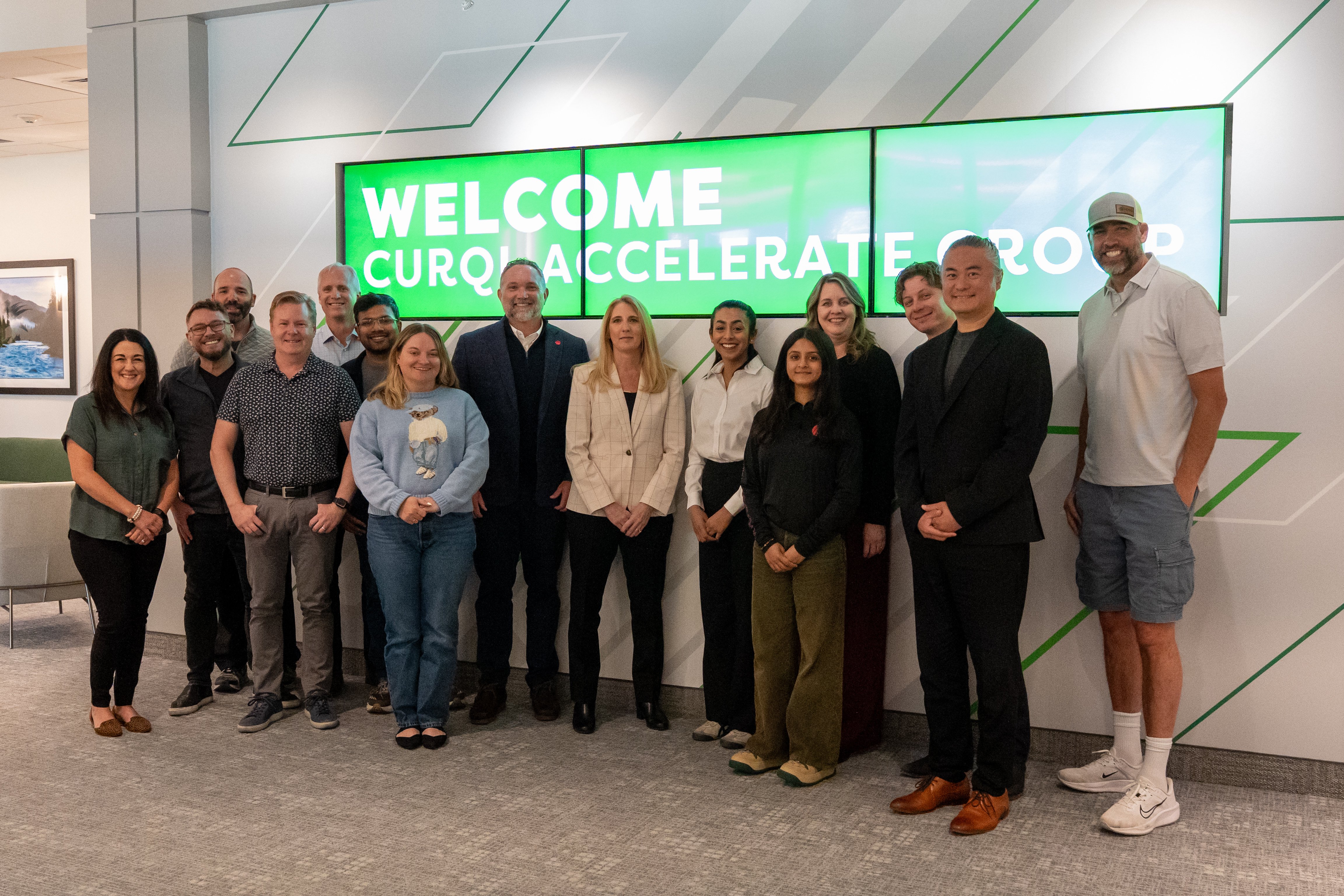 A Curql Accelerate fintech founder arriving at a Curql credit union, greeted by a warm welcome banner at HQ